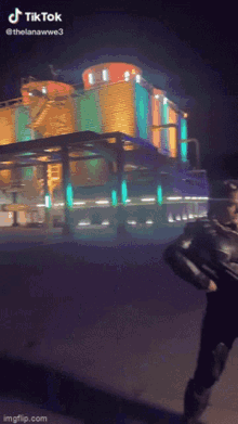 a person is standing in front of a building that says tik tok