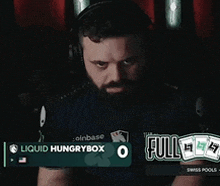 a man wearing headphones and a liquid hungry box shirt
