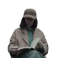 a woman wearing a plaid coat and a hat is reading a book