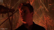 a man standing in front of a fire with the words welcome written on the screen