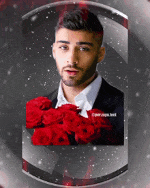 a man in a suit is holding a bouquet of red roses in front of his face