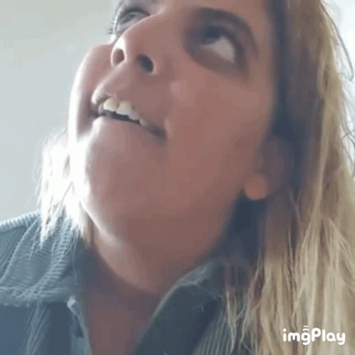 a close up of a woman 's face with the words imgplay visible