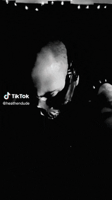 a black and white photo of a man wearing headphones and a tiktok logo