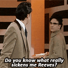 a man in a suit is talking to another man who is holding a tray of food