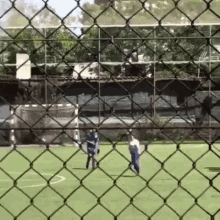 a man in a blue shirt is playing soccer on a field