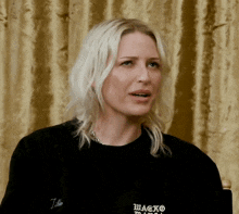 a woman wearing a black shirt that says wagko