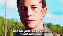 a man with a circle on his forehead is talking about a circle .