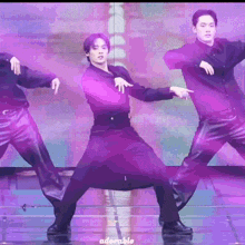 a group of men are dancing on a stage with adorable written on the bottom right