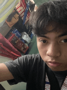 a young man taking a selfie with a camel branded lanyard around his neck