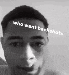 a black and white photo of a shirtless man with the words who want backshots on his forehead