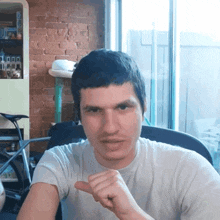 a man in a white shirt is pointing at the camera