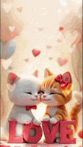 two kittens are kissing while holding the word love in their paws .