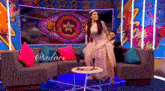 a woman in a wedding dress is dancing in front of a large eye .