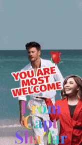 a man and woman on a beach with a sign that says you are most welcome from capt shafar