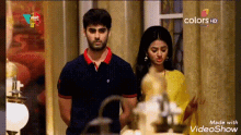 a man and woman are standing next to each other in a room .