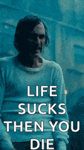 a man in a white sweater with the words life sucks then you die on it