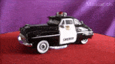 a sheriff 's car is sitting on a red carpet .