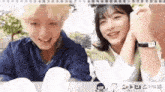 a boy and a girl are sitting next to each other smiling