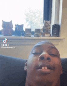a man is laying on a couch with his eyes closed and a tiktok post by meat man437