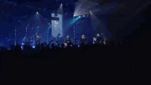 a man in a hat is playing a guitar on stage