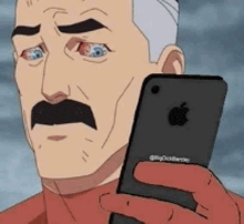 a man with a mustache is holding a black apple iphone