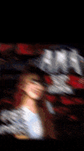 a blurry picture of a woman in a white shirt with a red background