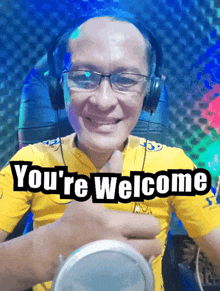 a man wearing headphones giving a thumbs up with the words you 're welcome behind him