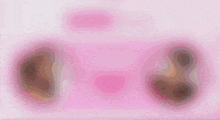 a pink background with a few circles on it .