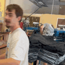 a man in a white shirt stands in front of a machine