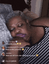 a woman in a striped shirt is sleeping on a bed with keys on the pillows
