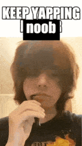 a young man is smoking an electronic cigarette with the words keep yapping i noob above him