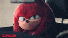 knuckles from sonic the hedgehog is sitting in a car and giving the middle finger