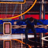 a man dancing on a stage with a sign that says family feud canada on it