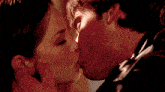 a man and a woman are kissing in a close up