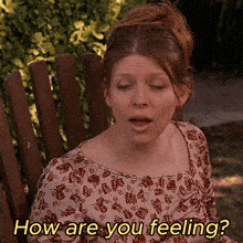 a woman sits in a wooden chair with the words how are you feeling