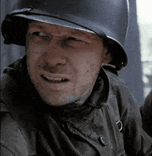 a man wearing a helmet and a jacket with a button on it