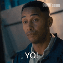 a man in a blue jacket says yo on his face