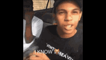 a man wearing a shirt that says " i know " on it