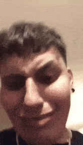 a close up of a man 's face with a smile on his face .