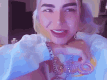a close up of a woman 's face with a necklace that says candy on it