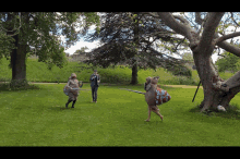 a group of people standing in a park with swords
