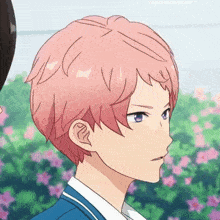 a boy with pink hair and purple eyes is standing next to another boy .