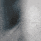 a gray and black background with a shadow of a person