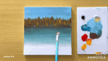 a painting of a forest is being painted on a wooden table