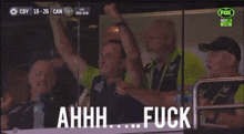 a group of men sitting in a stadium with a fox logo on the bottom right