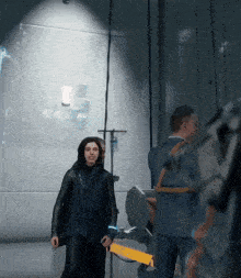a man in a suit is standing next to a woman in a black coat