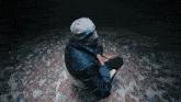 a person wearing a mask is sitting on a chair in front of a pile of money