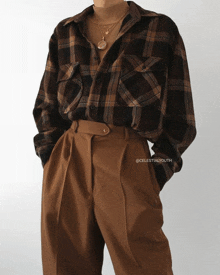 a woman wearing a plaid shirt and brown pants is sponsored by celestialyouth