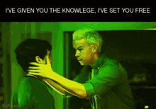 a man in a green shirt is hugging another man in a green room