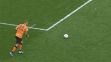 a soccer goalie is diving to catch a ball in front of a sky bet banner